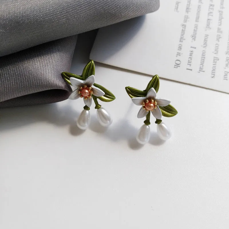 Women's flower ear clip earrings with sterling silver needle flowers and contrast colour alloy metal design