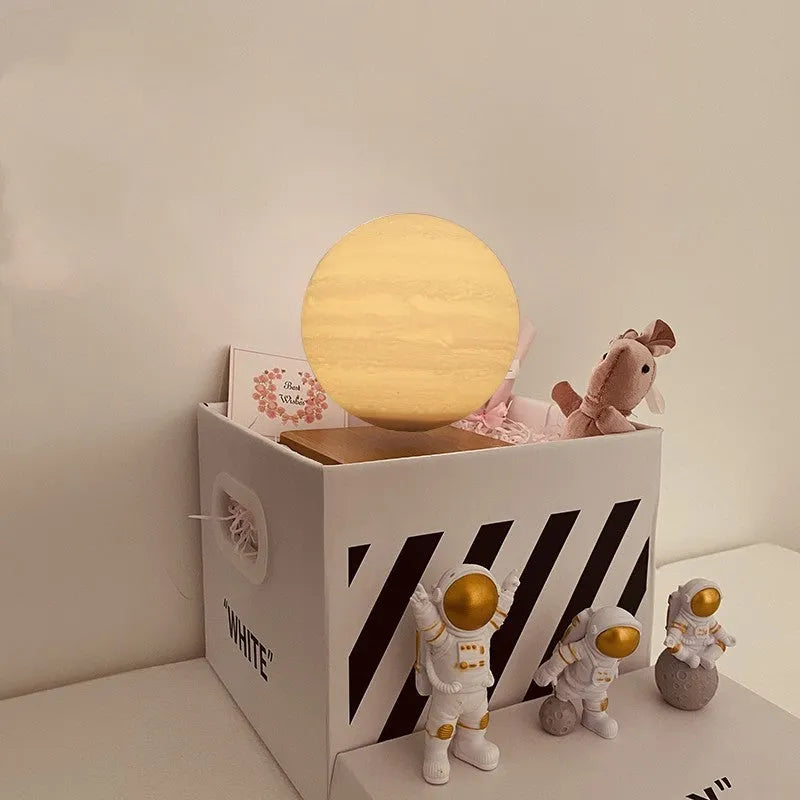 Maglev floating planet night light with LED glow, astronaut figurines, and USB cable.