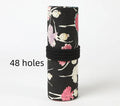 Square canvas rolling pencil case with ballet girl print, showing interior holes for storing pencils.