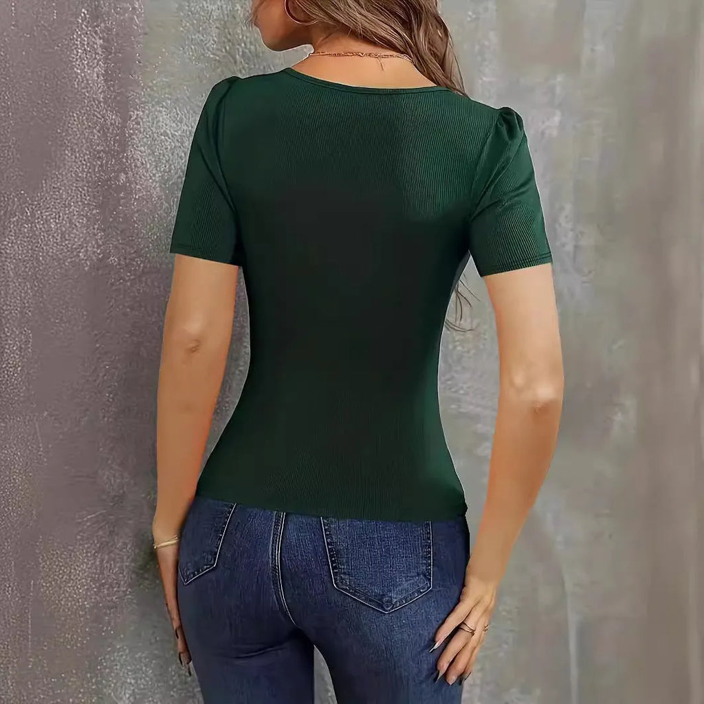 Woman wearing a wine red slim fit knitted short sleeve pullover top with a low neckline.