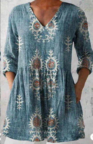 Women's printed loose wave dress with wide waist and three-quarter sleeves in a floral pattern.