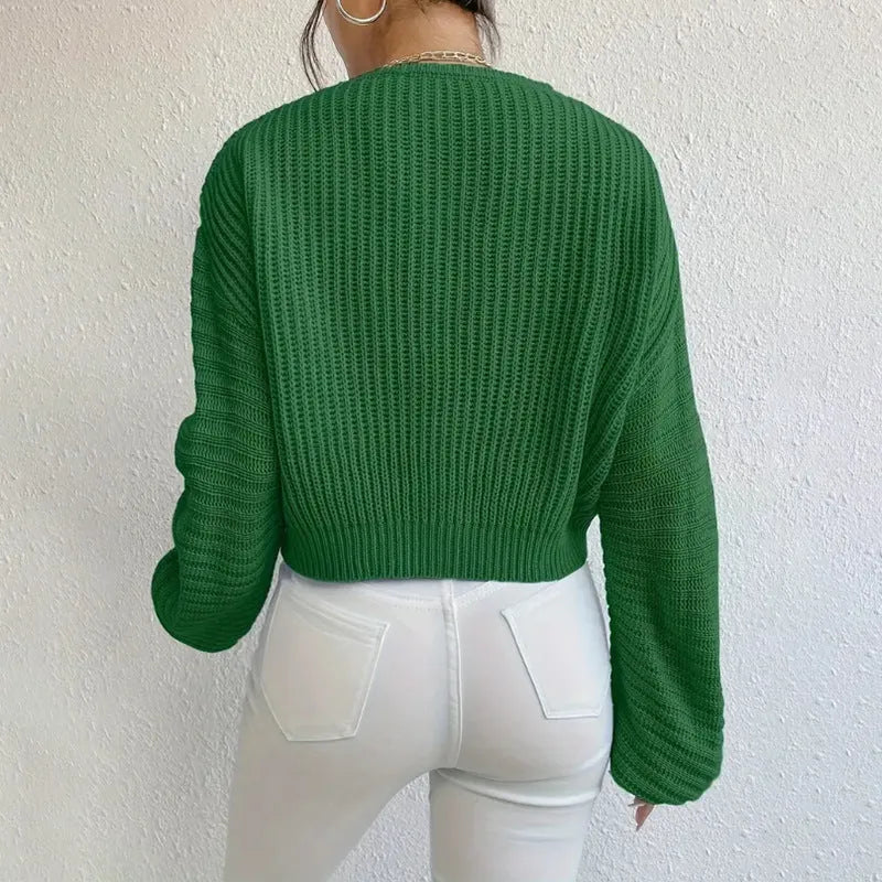 A woman wearing a solid colour long sleeve pullover in a loose, casual fit.