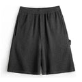 Cement grey polyester sports shorts with straight cut and fifth pants length on mannequin
