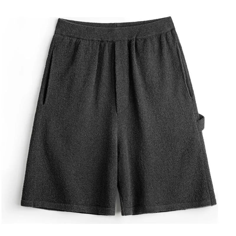 Cement grey polyester sports shorts with straight cut and fifth pants length on mannequin