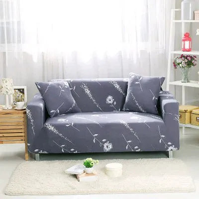 Geometric abstract printed stretch sofa slipcover covering a three-seater sofa with matching cushion covers.