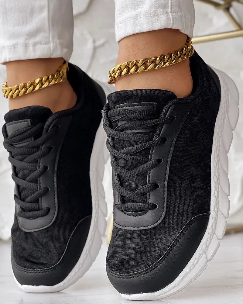 Women's canvas running shoes in white, black, blue, and pink colours with flat heel design