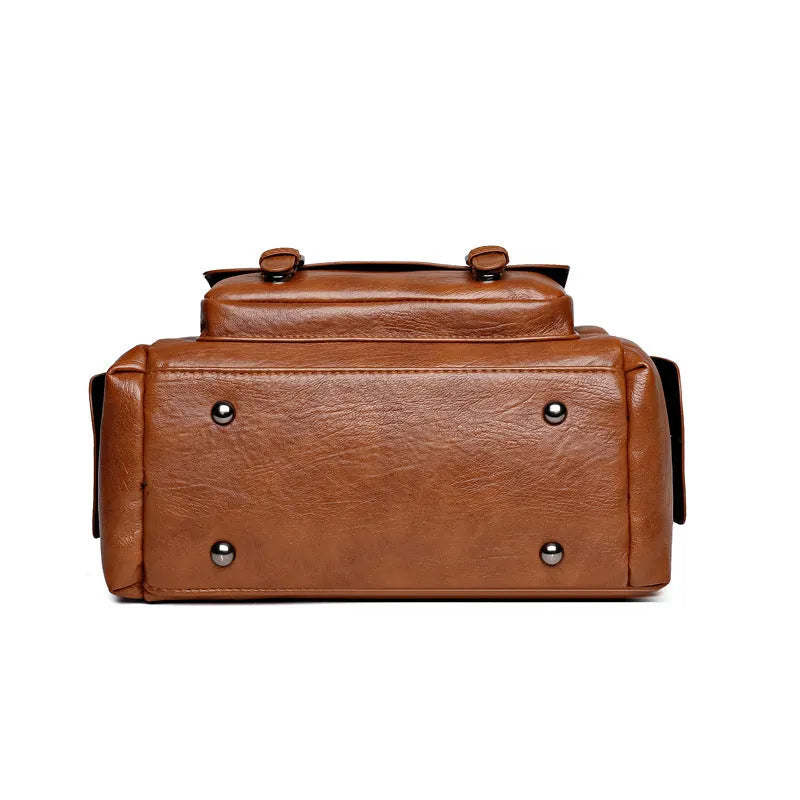 Vintage-style large messenger bag in PU leather, showing horizontal square shape and contrast stitching.