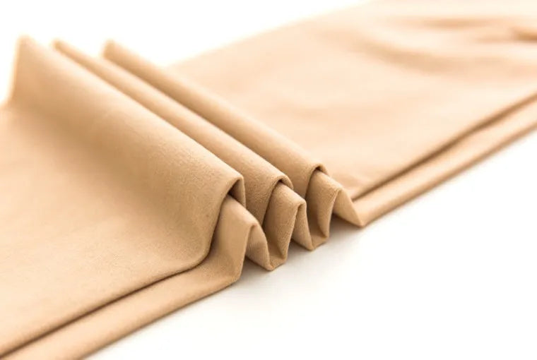 Beige and black lifting hips and abdomen stovepipe socks made from polyester fibre.