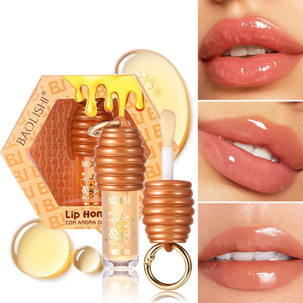 Honey coloured lip gloss on a silver keychain ring against a plain background.