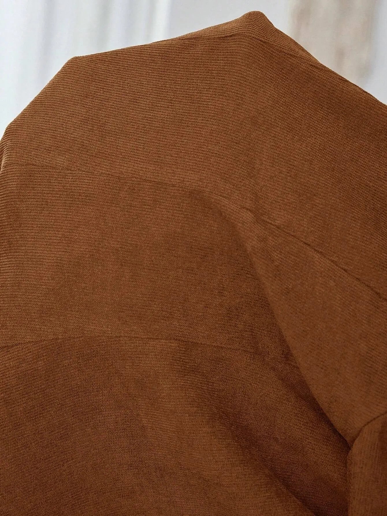 Brown men's single-breasted suit coat with lapel collar and long sleeves.