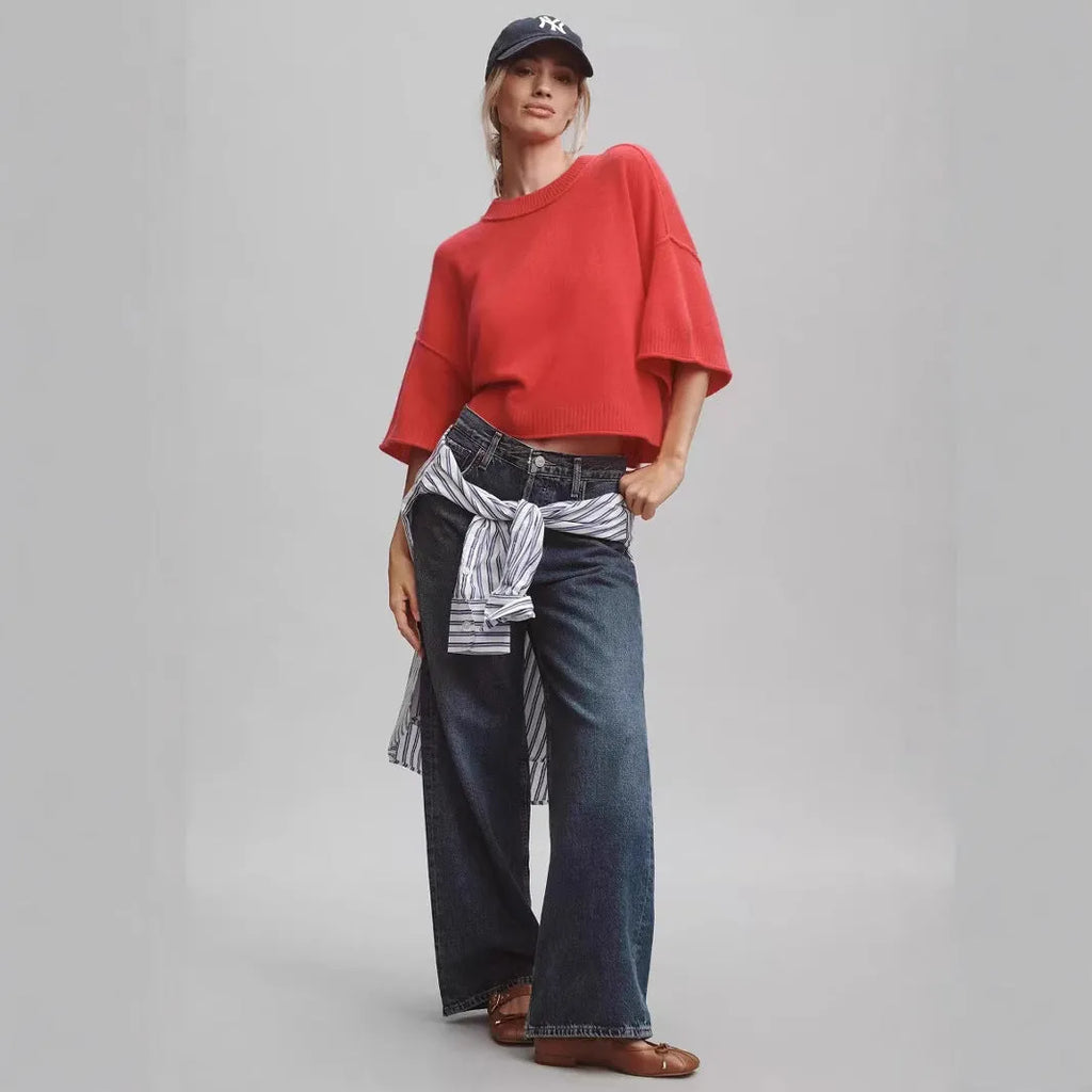 Red women's crop top t-shirt with regular sleeves on a hanger.