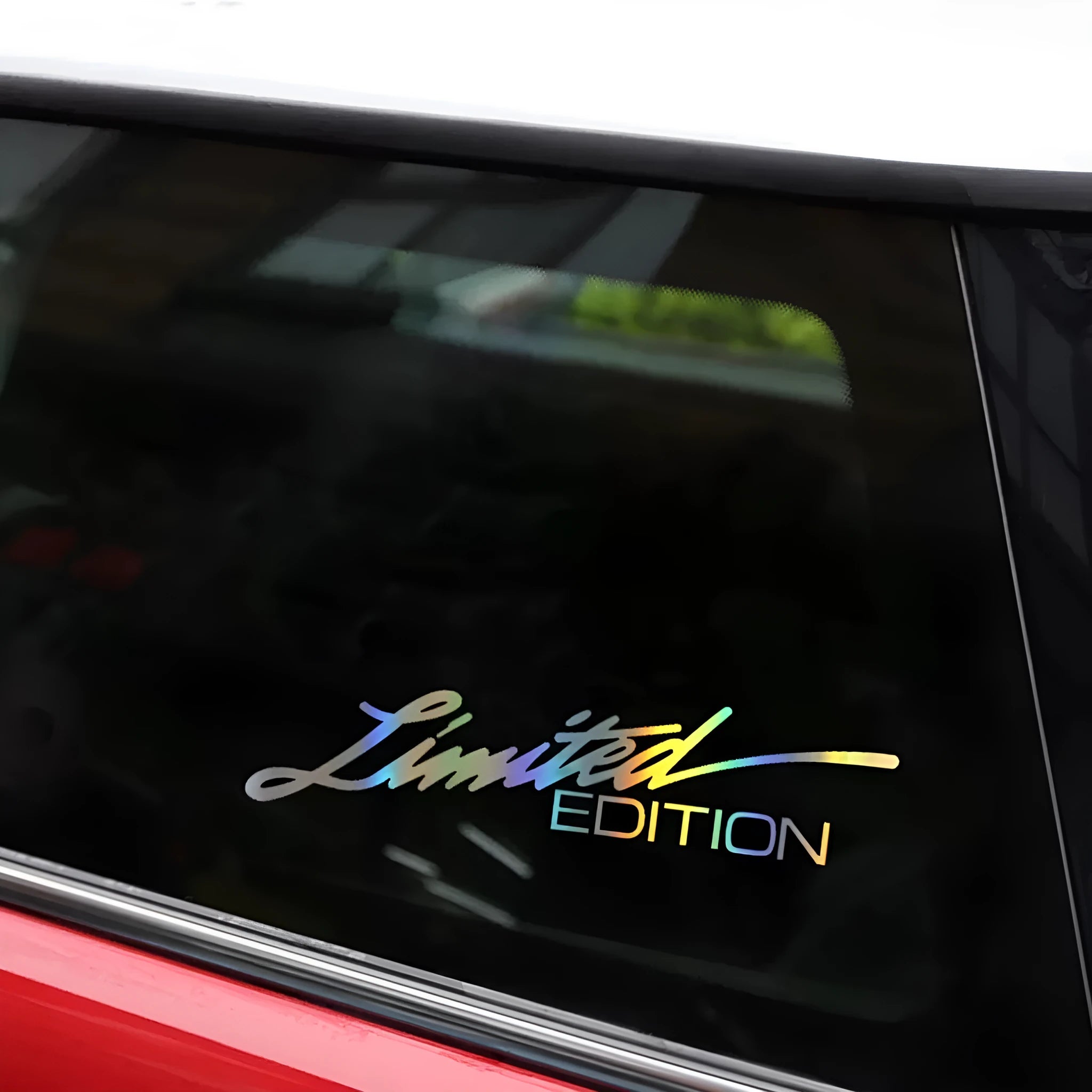 Black laser reflective text car sticker on a vehicle window.