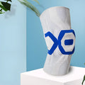 Silicone knee pad for men in black and blue colour, shown on a knee during activity.