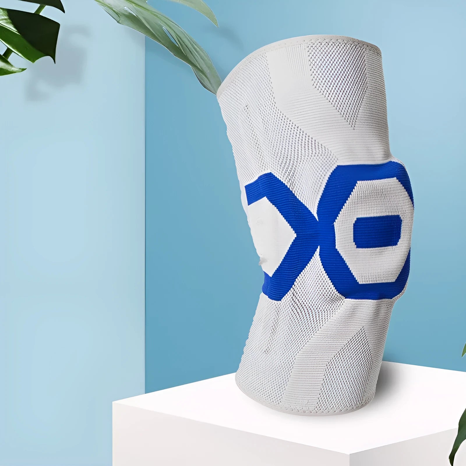 Silicone knee pad for men in black and blue colour, shown on a knee during activity.