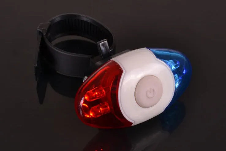 Red and blue LED bicycle tail light with adjustable mounting base shown in horizontal position.