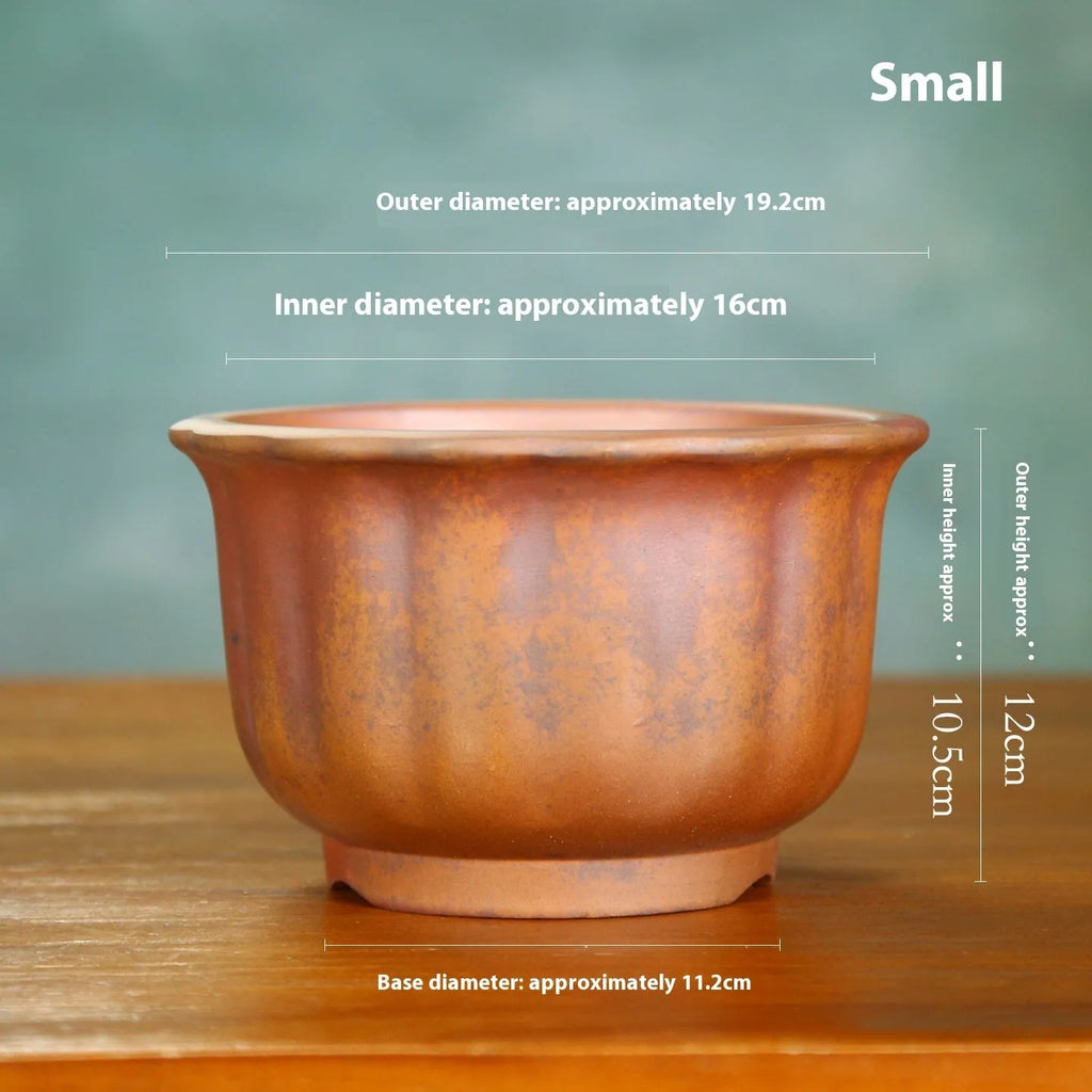 Large indoor ceramic flowerpot with antique carved flower design in purple sand clay