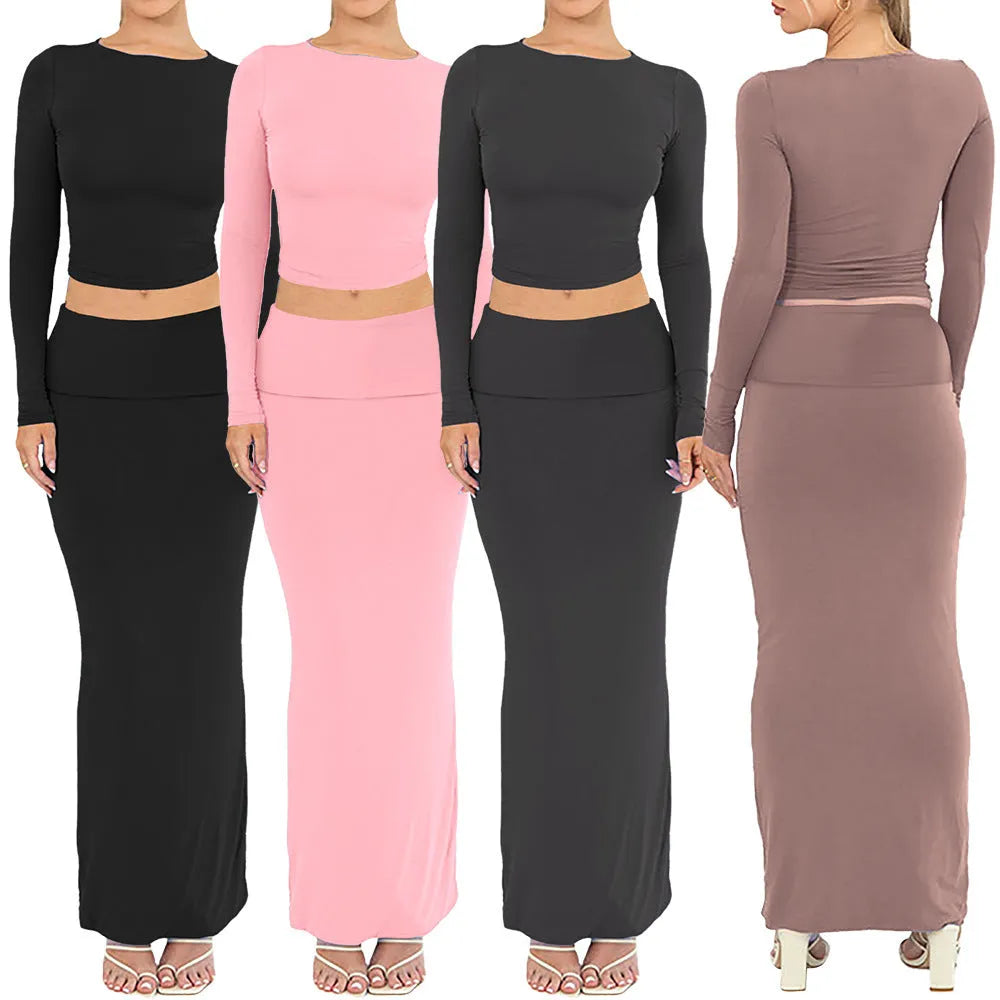 Women's black slim fit two-piece suit set with three-quarter sleeve top and long skirt on a model.