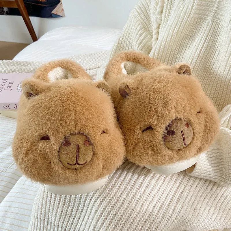Light brown women's plush winter slippers with artificial wool lining and a PVC sole.