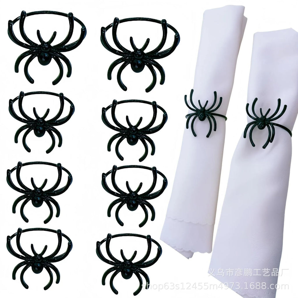 Set of six black alloy spider-shaped napkin rings for Halloween table decoration