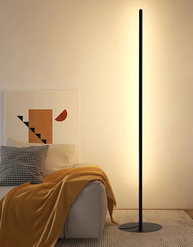 A tall, vertical aluminium alloy floor lamp with a modern design on a simple base.
