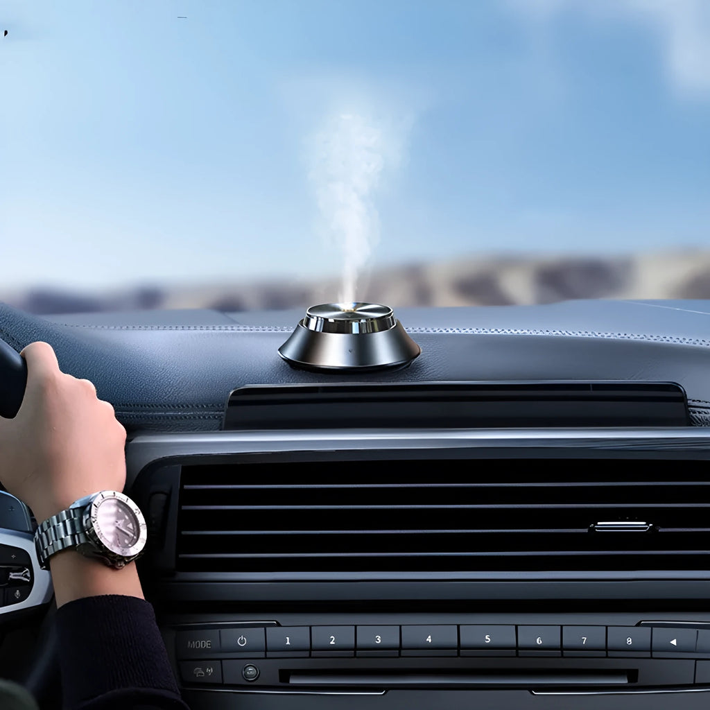 Black butterfly-shaped metal car aromatherapy air purifier with USB cable and essential oil bottle.