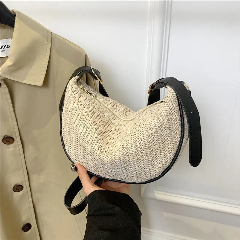 Women's woven straw crossbody bag showing internal phone pocket and file compartment