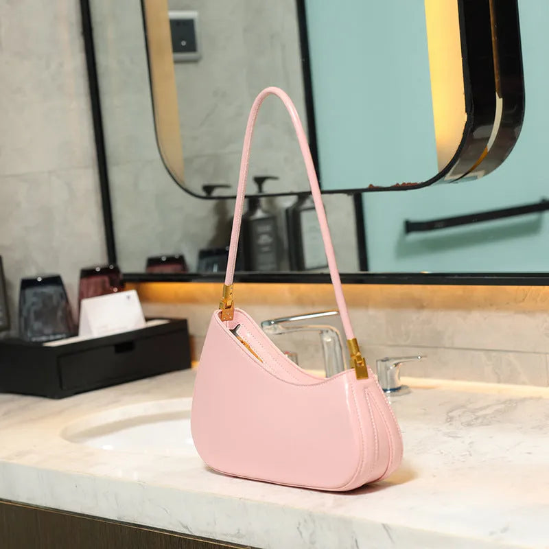 Women's oval shaped underarm bag in PU leather with single shoulder strap and internal zipper compartment