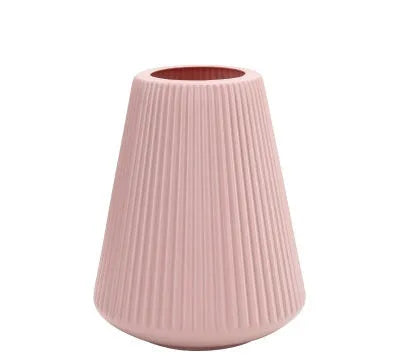 A simple style melamine plastic decorative flower vase in blue, measuring 16cm by 20cm, on a desktop.