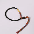 Hand-woven obsidian carrying strap bracelet showing woven texture and 4mm width