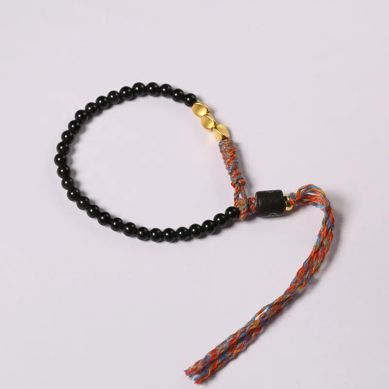 Hand-woven obsidian carrying strap bracelet showing woven texture and 4mm width