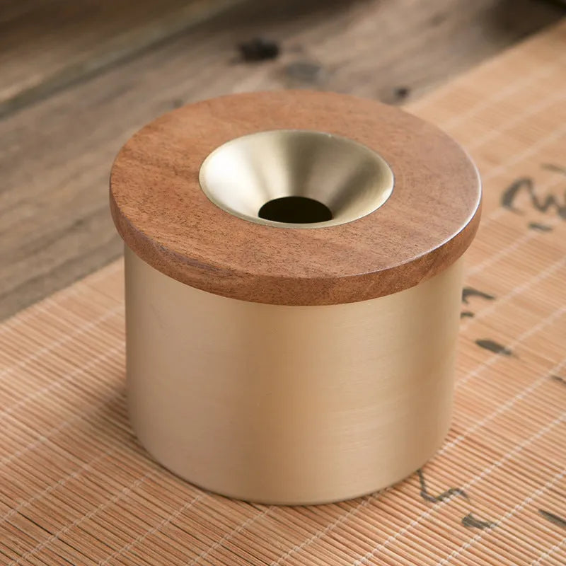 Retro brass ashtray with wooden lid showing copper construction and central hole design