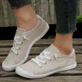 Women's creamy-white fabric casual sneakers with rubber soles shown in low-top design