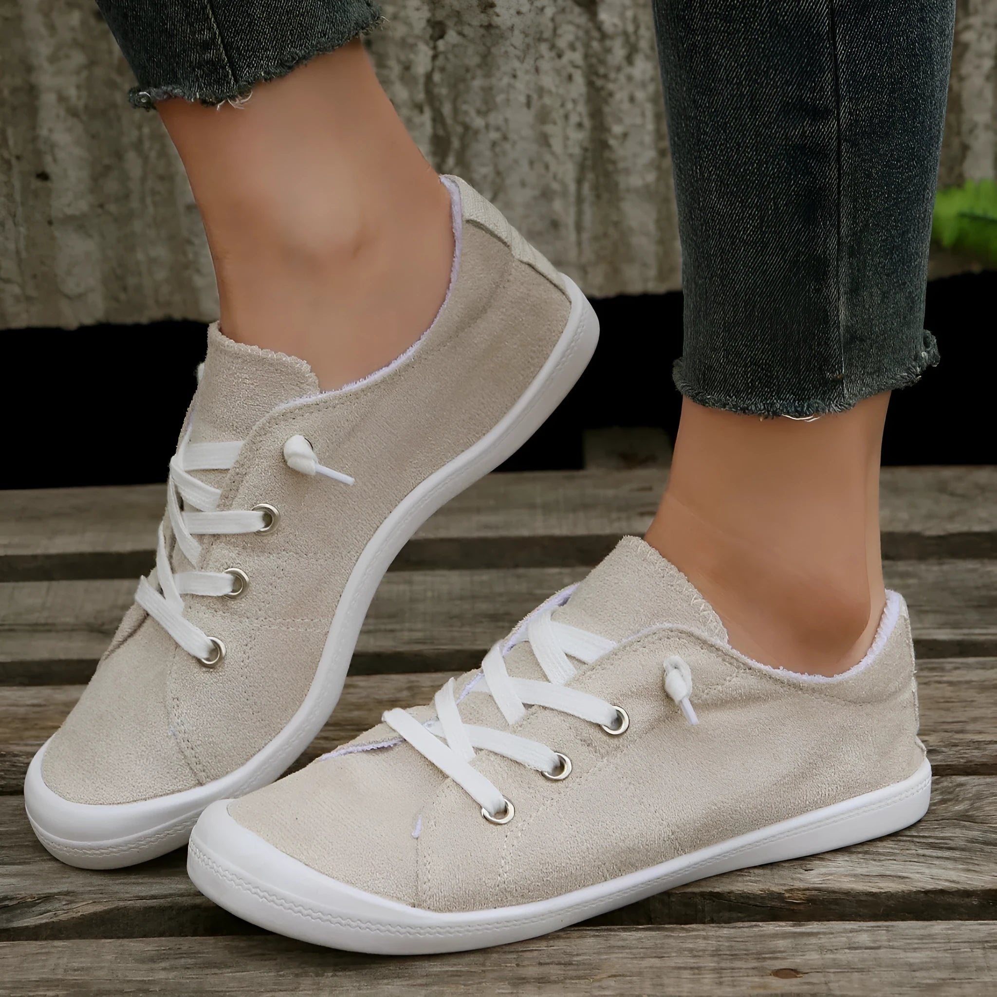 Women's creamy-white fabric casual sneakers with rubber soles shown in low-top design
