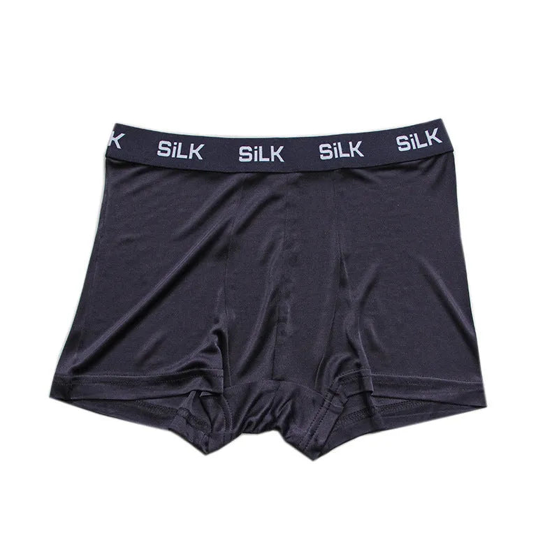 Men's loose silk shorts in navy blue, showing mid waist and relaxed fit.