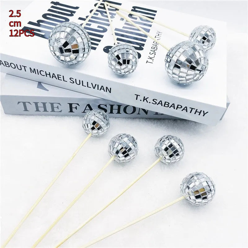 Glass disco ball cake decoration on a wooden stick, shown in different sizes.