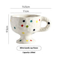 Handmade ceramic mug with irregular shape in solid colour