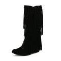 Women's black suede knee-high boots with a chunky heel and tassel decoration.