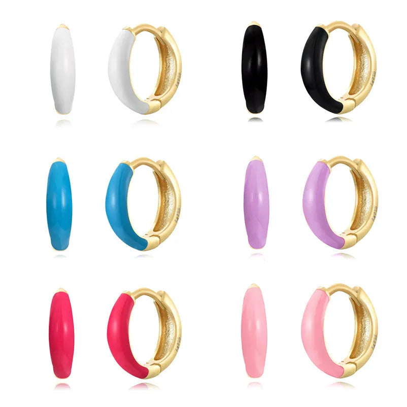 Geometric U-shaped silver wire drop earrings with glossy oval epoxy resin elements in various colours.