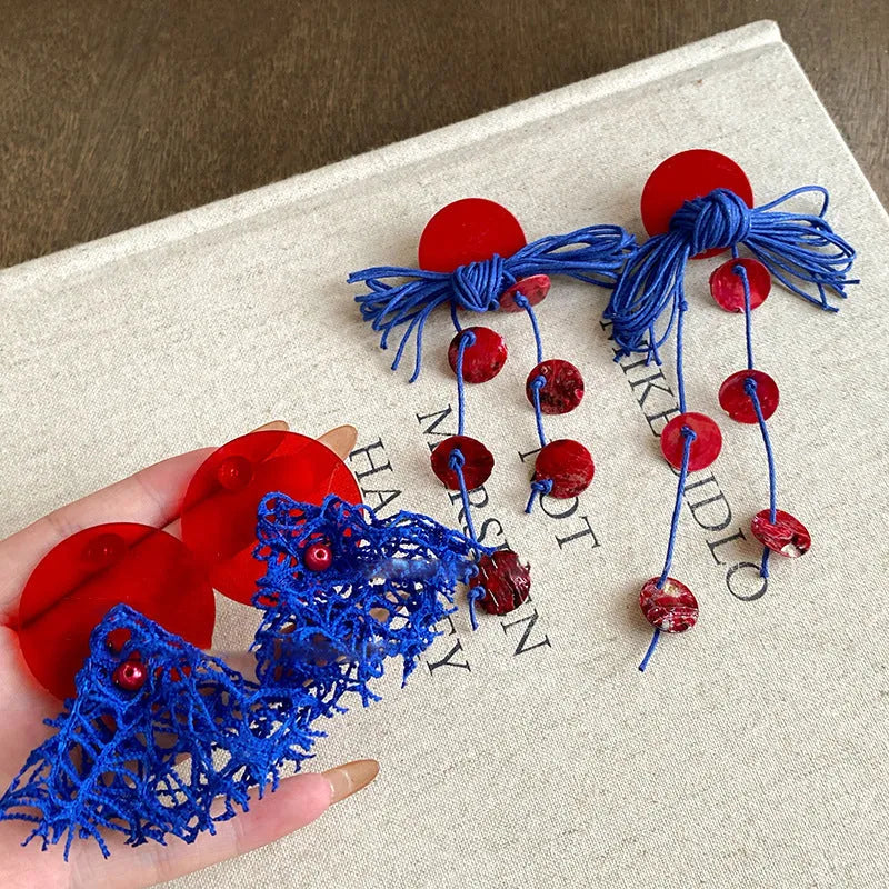 Women's geometric earrings with blue resin flower design on cloth material