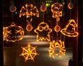 Seven Halloween LED lights with suction cups featuring spider, pumpkin and ghost designs for window decoration