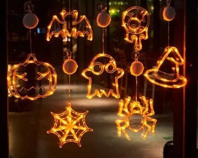 Seven Halloween LED lights with suction cups featuring spider, pumpkin and ghost designs for window decoration