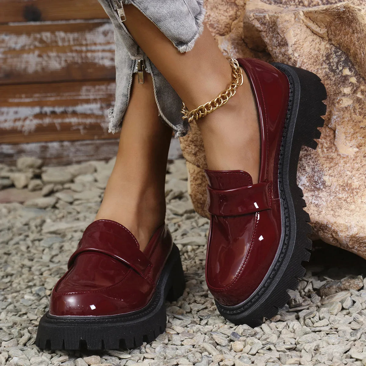 Women's black slip-on loafers with a chunky block heel and platform sole, shown from the side.