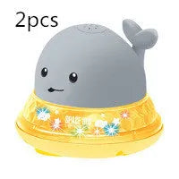 Electric whale-shaped baby bath toy with water spray, LED lights, and automatic water sensor