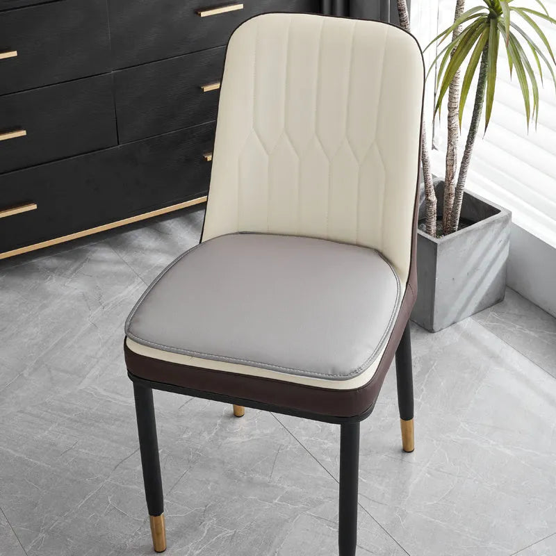 Leather horseshoe-shaped non-slip seat cushion in a solid colour on a chair.