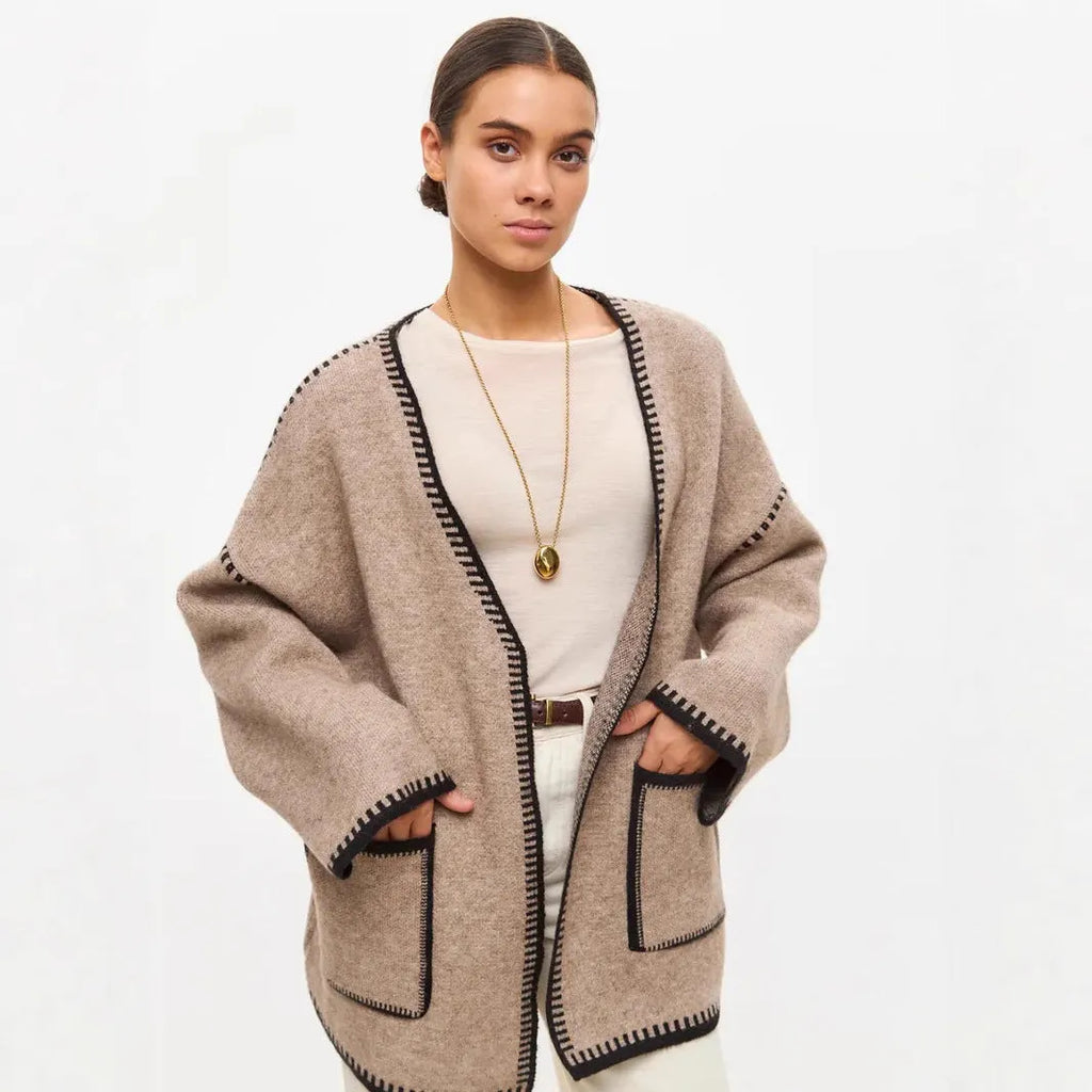 Lace-up front knitted cardigan sweater coat in camel colour, showing loose fit and long sleeves.