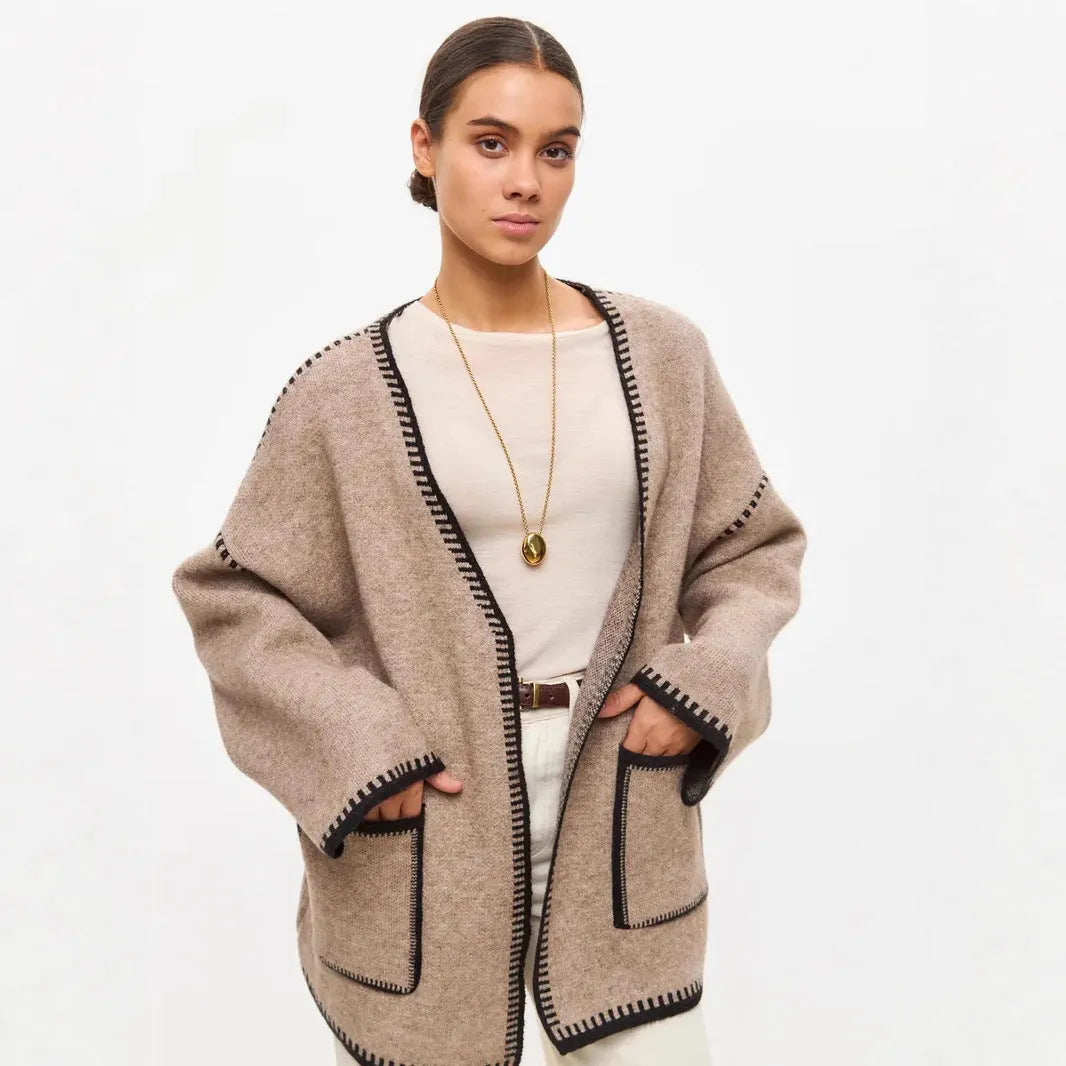 Lace-up front knitted cardigan sweater coat in camel colour, showing loose fit and long sleeves.