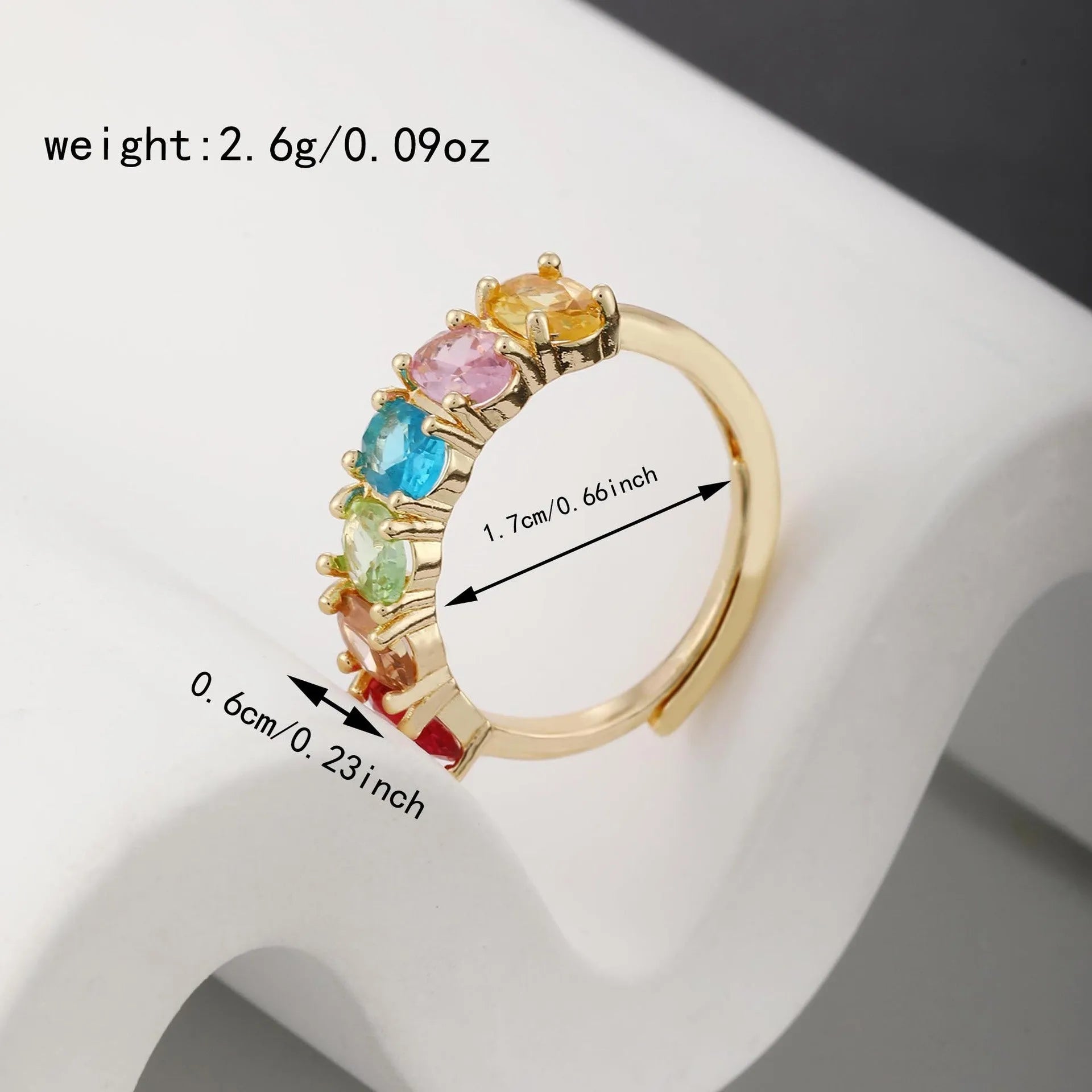 Gold electroplated women's zircon ring with adjustable size on display