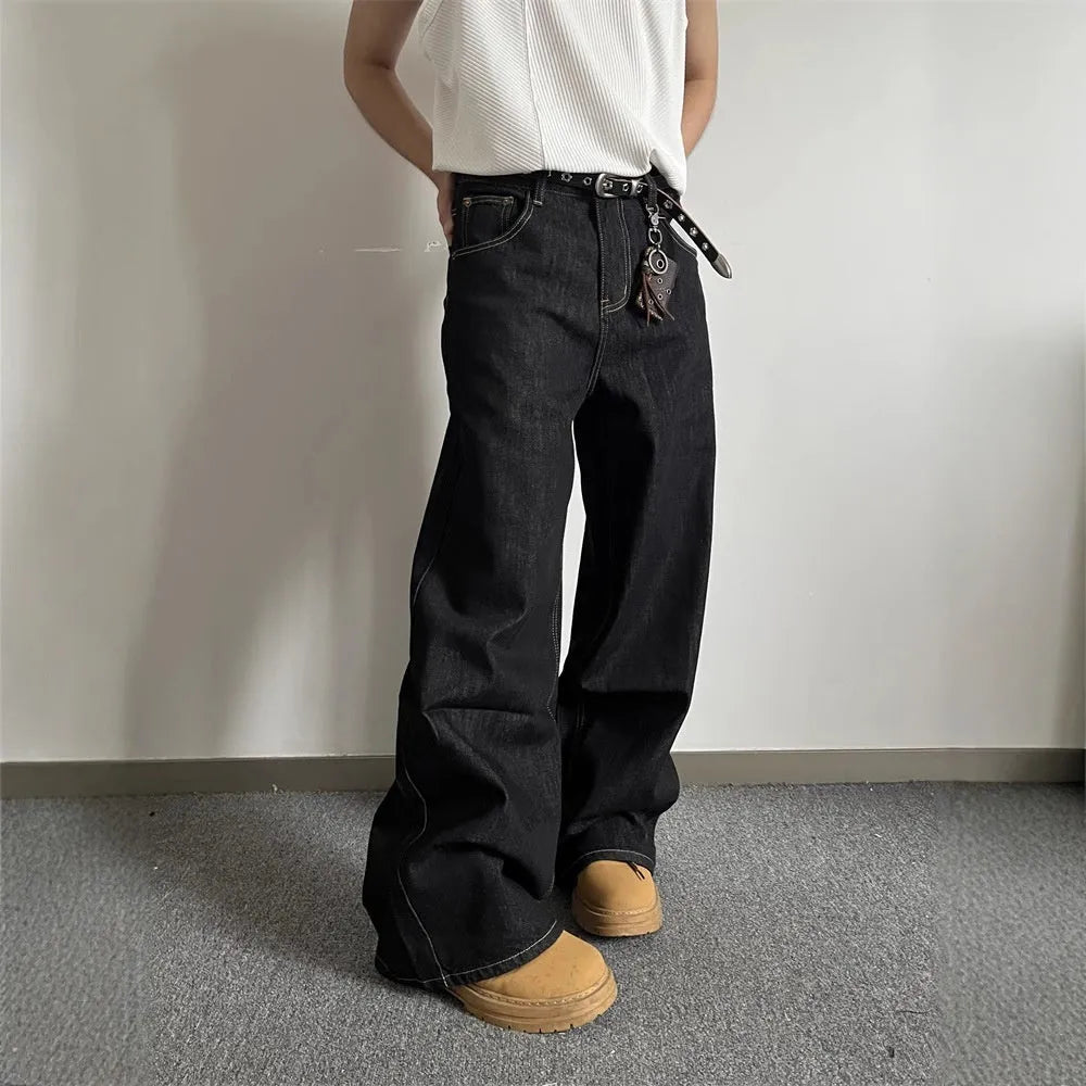 A pair of black loose wide-leg jeans with a straight-leg cut and zip fly on a mannequin.