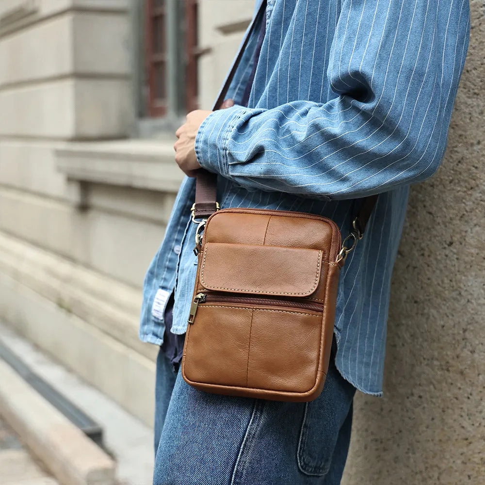 Men's brown genuine leather crossbody shoulder bag showing sewing line details.