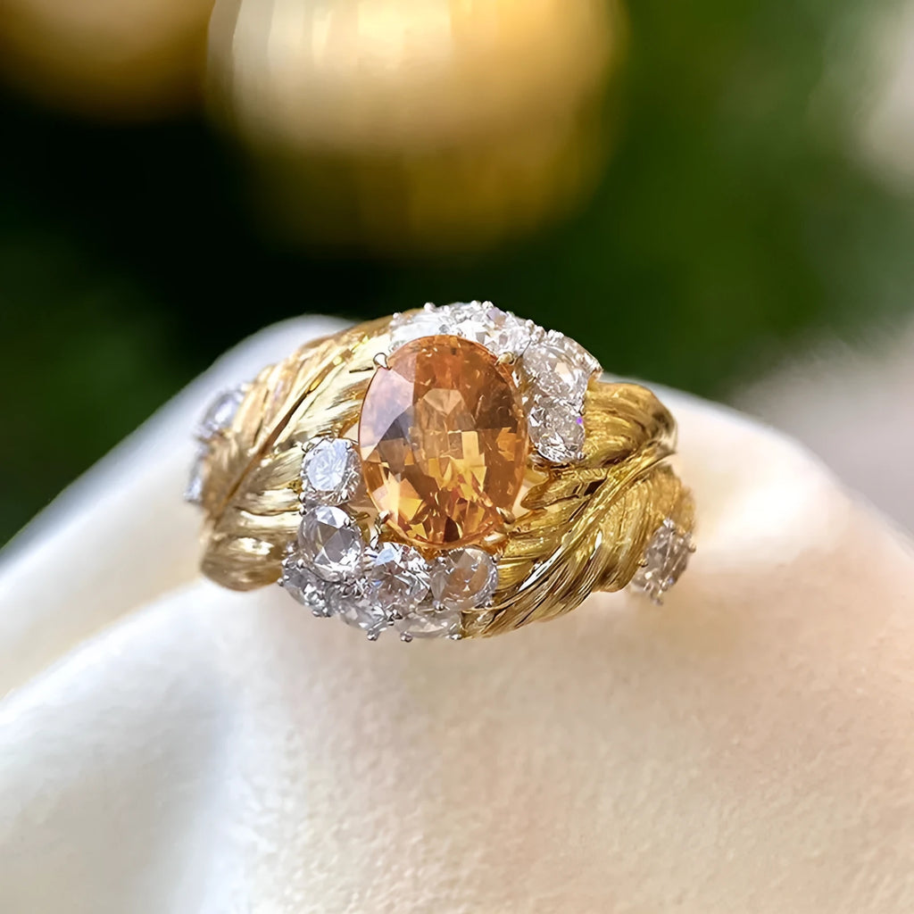 Gold coloured embossed feather ring with geometric design and yellow zircon stone inlays